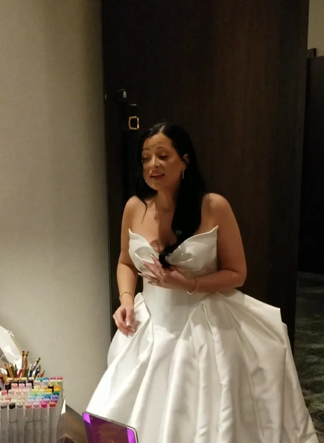 A bride looking at her sketch