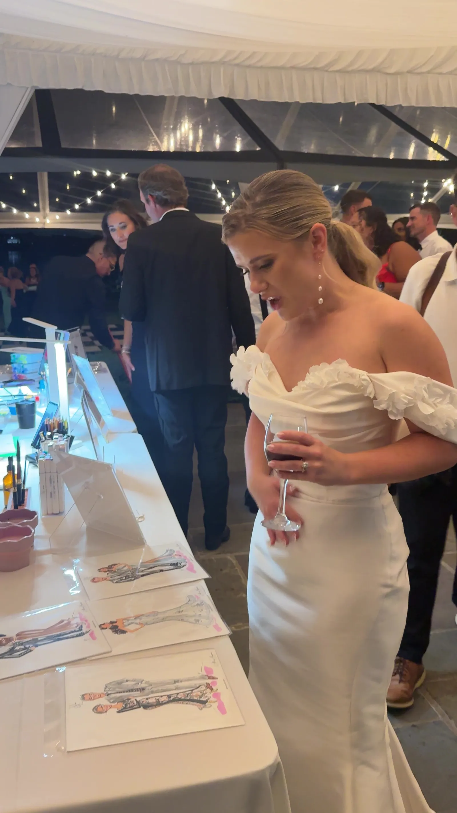 A bride smiling at the sketching table