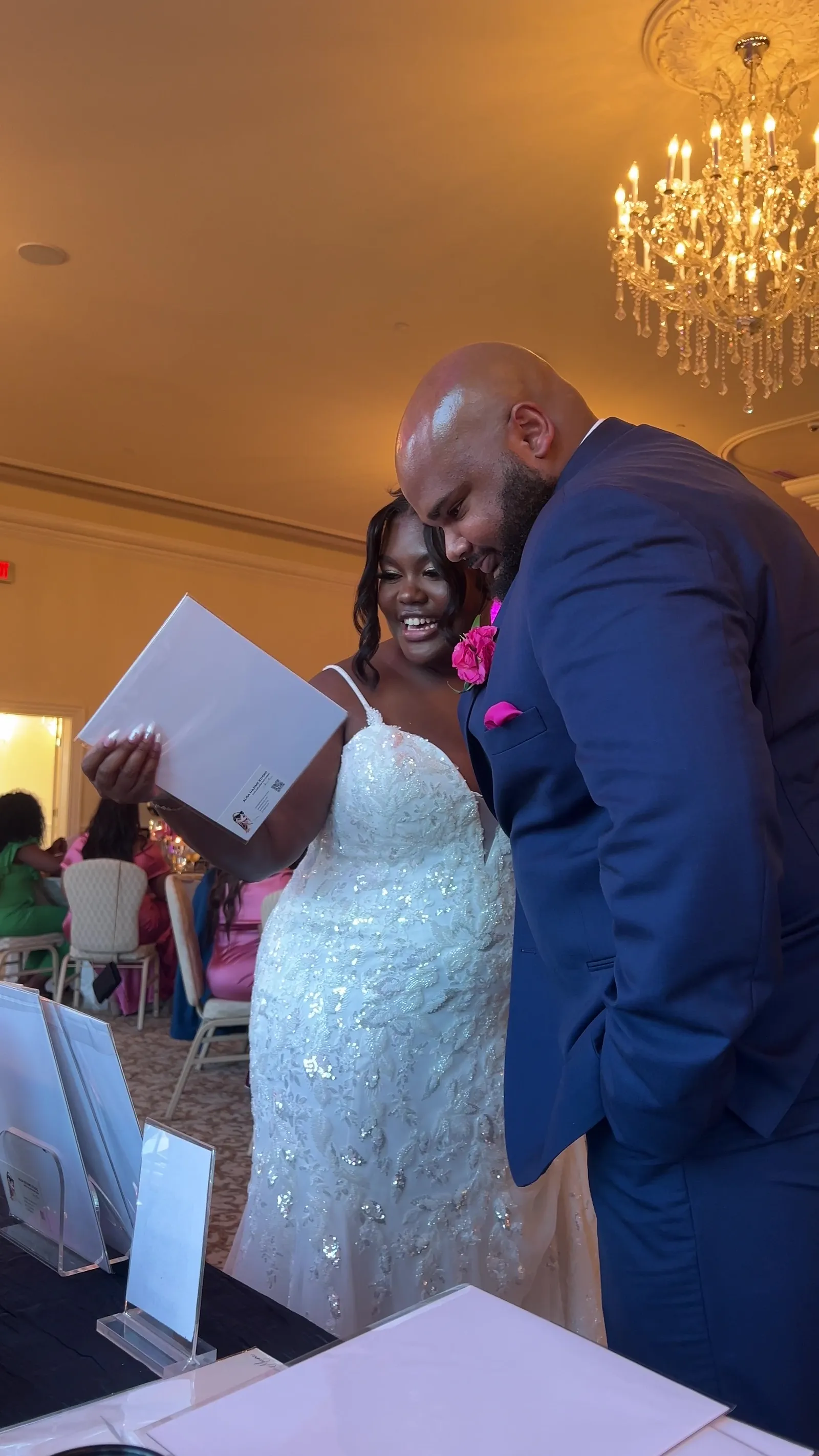 A bride and groom reading their sketch