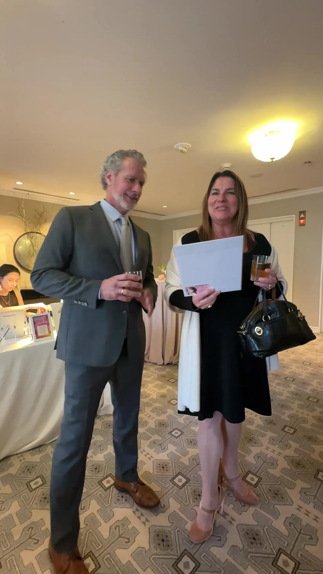 A bride holding her sketch with her father